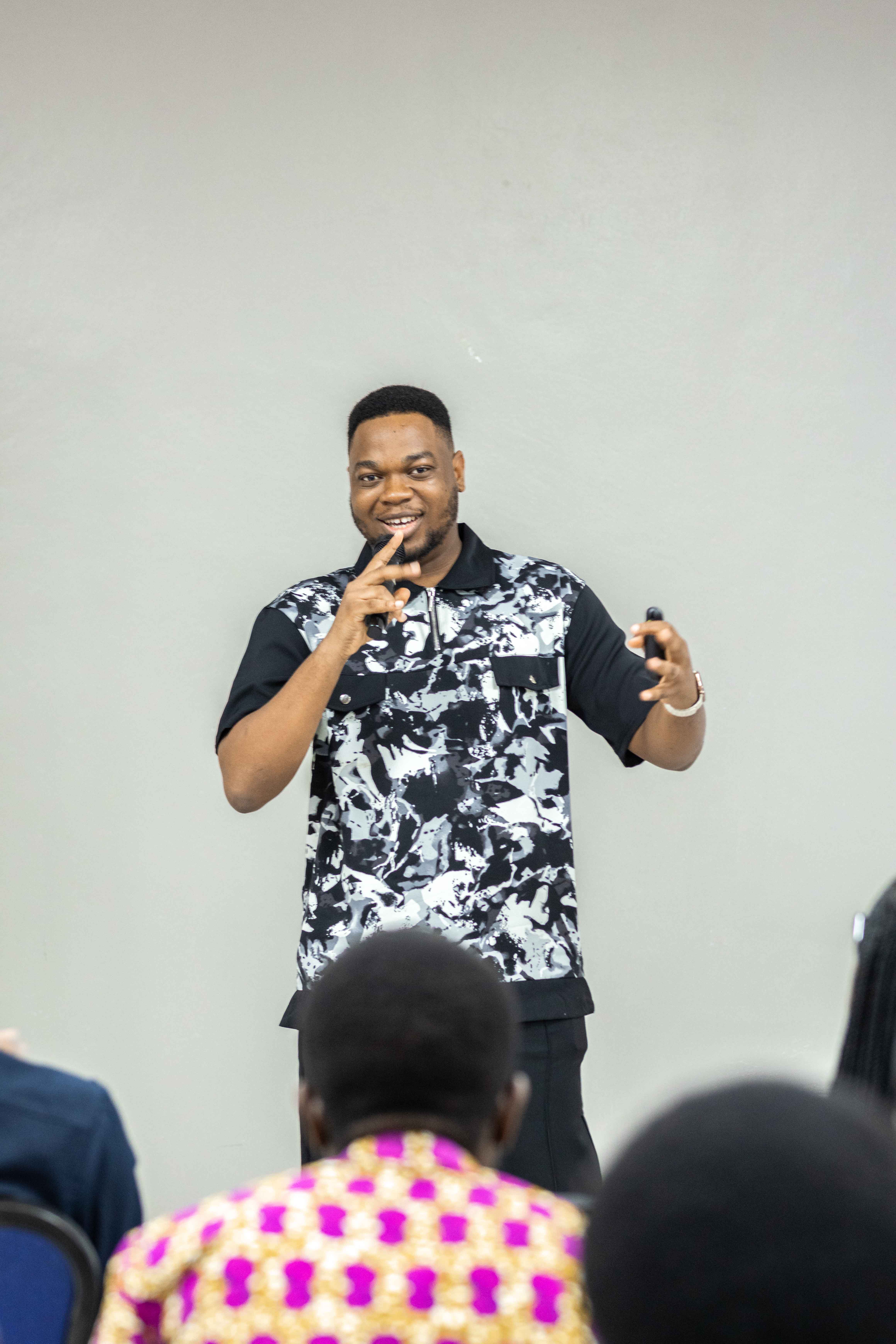 Samuel speaking with a microphone